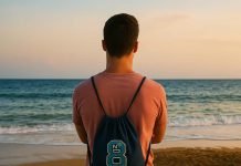 Ways to Boost Your Brand Visibility with Custom Drawstring Bags (UK) Man with drawstring backpack watching sunset on the beach.