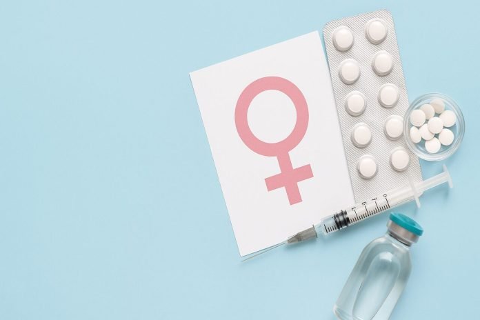 Hormone Replacement Therapy HRT supplies with female symbol card on blue background.