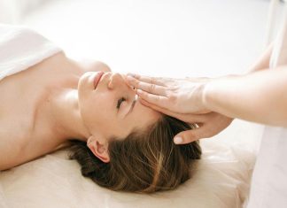 Simple Self-Care Habits Every Mom Can Fit Into Her Busy Day Woman receiving gentle Reiki or energy healing therapy at a spa.