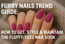 Furry Nails Trend Guide: How to Get, Style & Maintain the Fluffy Nail Look Close-up of a woman's hand with vibrant pink furry nails resting on a beige knitted fabric, showcasing the fluffy texture of the nail art.