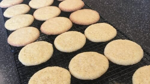 Freshly baked vanilla cookies cooling on a wire rack.