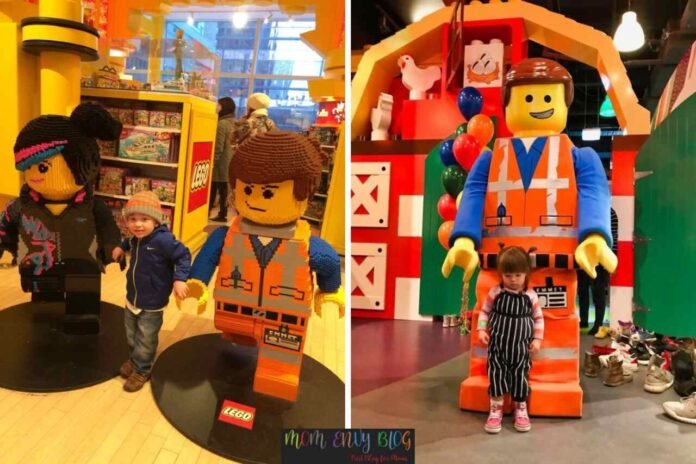 Children posing with LEGO Movie character statues and mascots at LEGO Discovery Center.