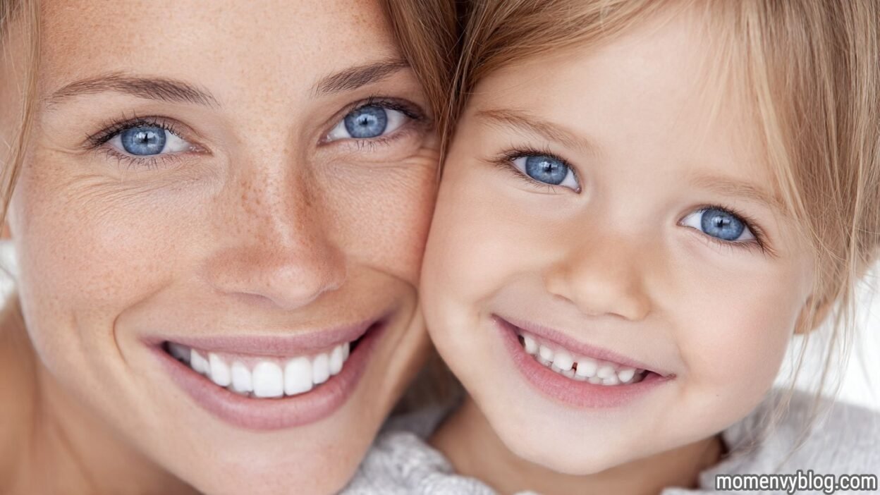 Smiling mother and young child showing healthy teeth during early childhood dental development