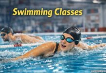 Swimming classes session with swimmer performing freestyle in pool