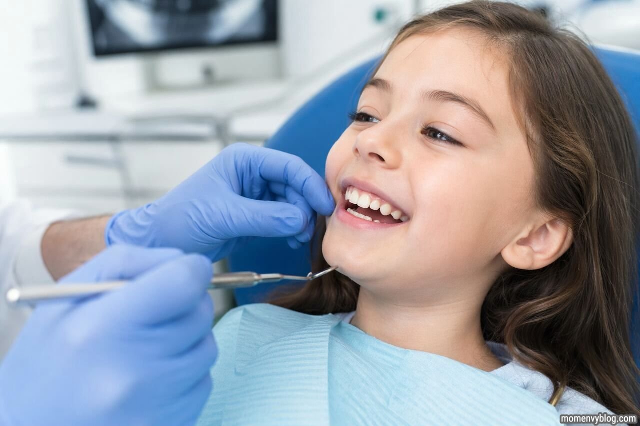 Young child smiling during a dental check-up while a dentist examines their teeth, focusing on natural teeth alignment in a clean clinic setting.